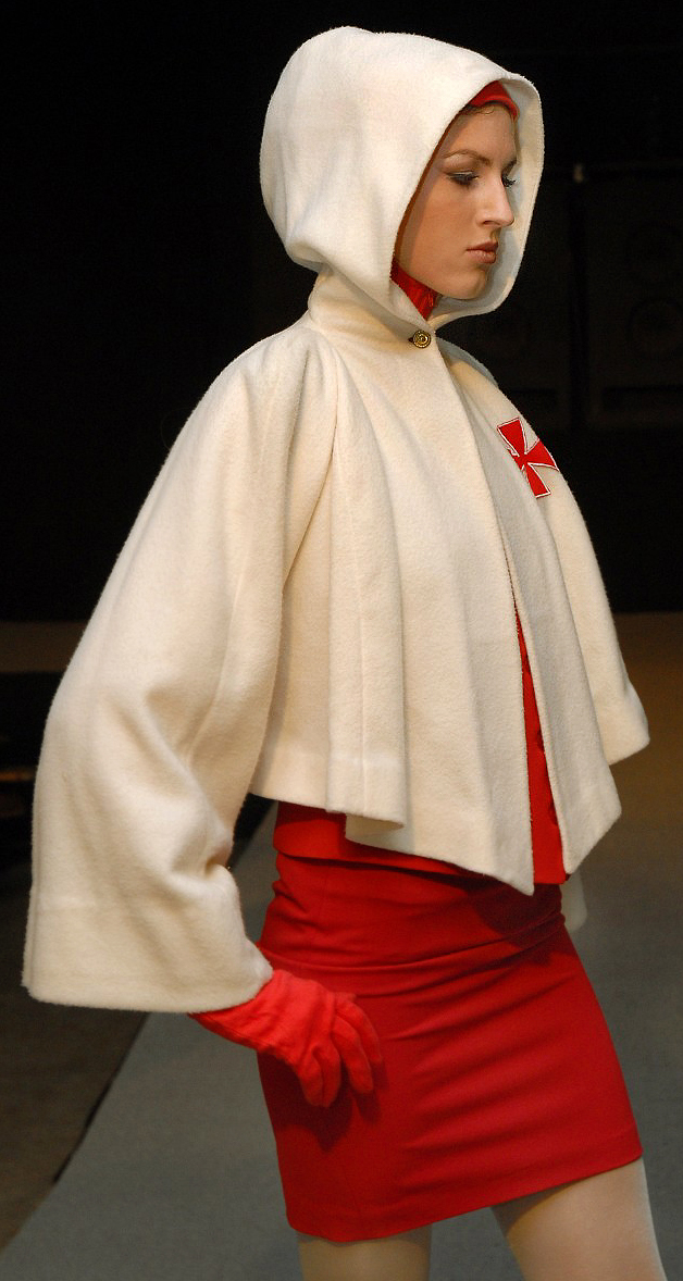 The catwalk model Lisa in a white cashmere sweater in Cape style with embroidery Templar symbol. German fashion designer Torsten Amft present during the Fashion Week Berlin his trend collection fall / winter 2008 - 2009. photographer M. Wittig